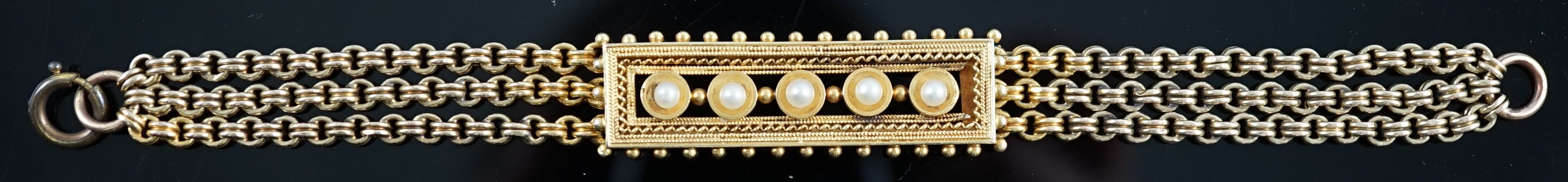 An early 20th century triple strand gold bracelet with central rectangular motif set with five cultured pearls